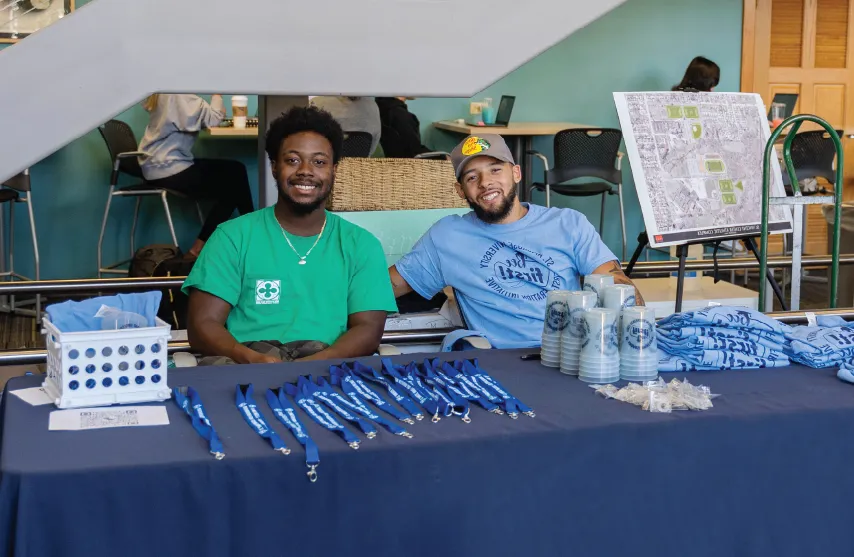 Students at table wearing first generation t-shirts.